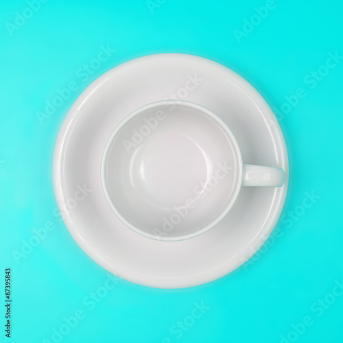 empty white coffee or tea cup on vibrant color background