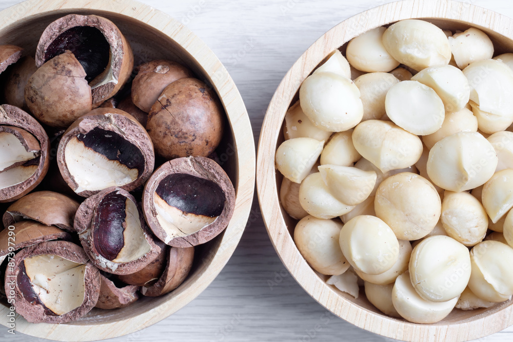 Top view macadamia nuts and shell in wooden bowl Top view macadamia nuts and shell in wooden bowl