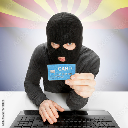 Hacker holding credit card with US state flag - Arizona photo