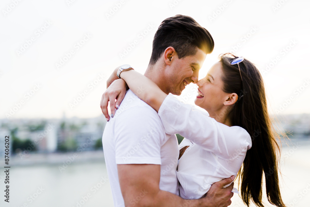 Young beautiful couple hugging and about to kiss