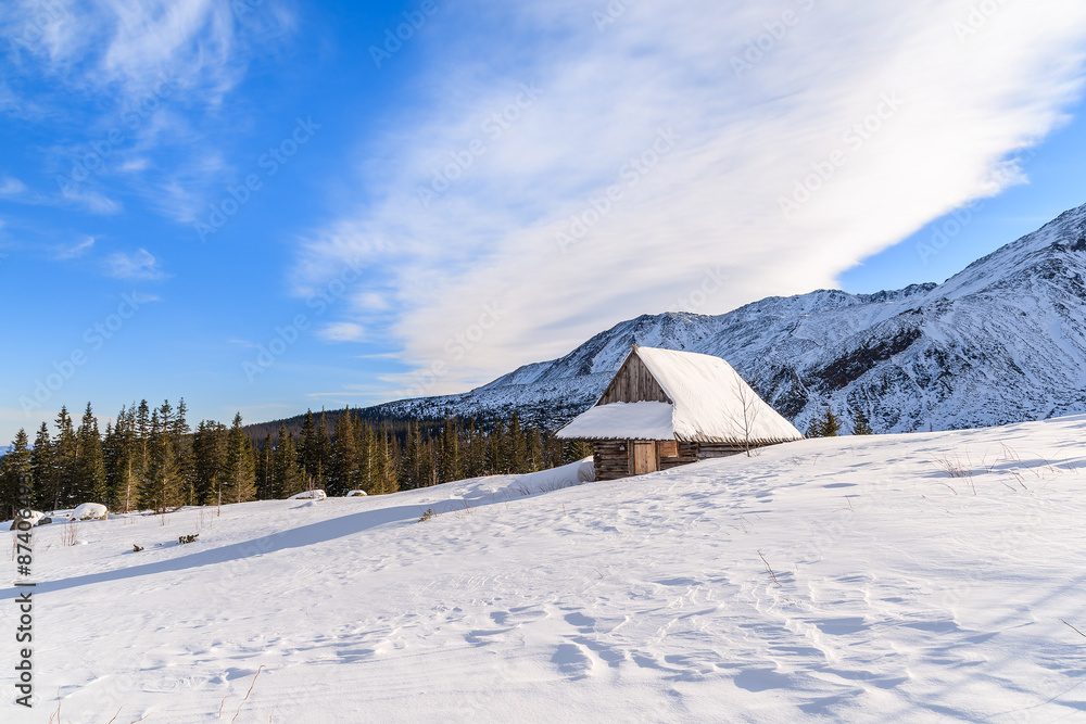 Wooden mountain hut in winter landscape of Gasienicowa valley, Tatra Mountains, Poland Wooden mountain hut in winter landscape of Gasienicowa valley, Tatra Mountains, Poland