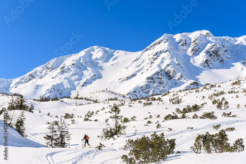 Mountains covered with snow and ski tourer on winter trail in Rohace valley, Tatra Mountains, Slovakia