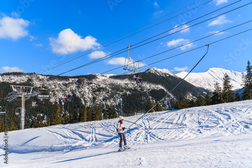 Skier on lift in beautiful winter scenery of Tatra Mountains, Slovakia