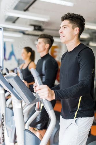 Young healthy group of people working out on a elliptic trainer