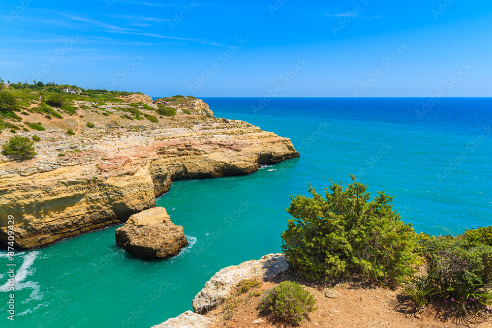 Sea bay with azure sea water on coast of Portugal near Carvoeiro town, Algarve region