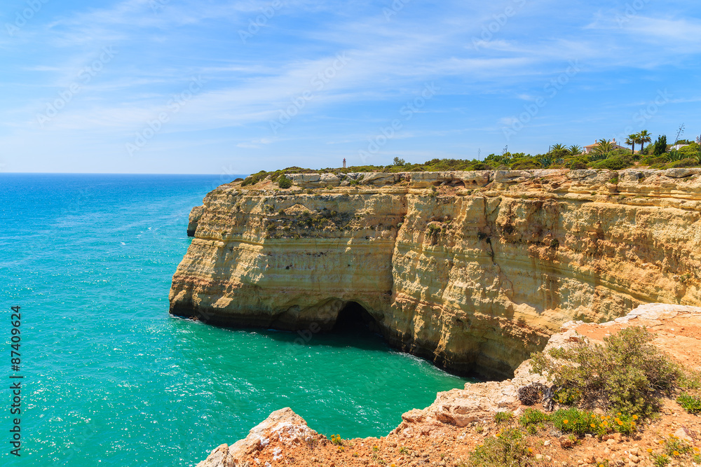 Turquoise sea and cliff rocks on coast of Portugal near Carvoeiro town, Algarve region