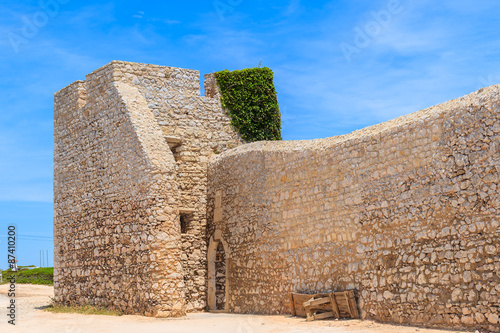 Stone wall of Fortaleza de Belixe castle near Cabo Sao Vicente, Portugal photo