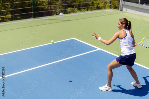 Beautiful female tennis player in action © NDABCREATIVITY