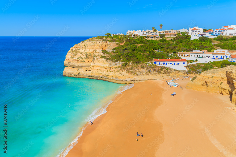 Obraz premium View of beautiful sandy Benagil beach and azure sea water in Algarve region, Portugal