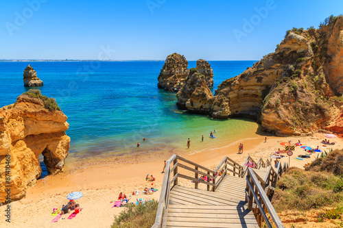 Wooden footbridge to beautiful beach Praia do Camilo, Portugal photo