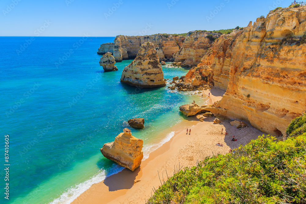Obraz premium View of beautiful Marinha beach with crystal clear turquoise water near Carvoeiro town, Algarve region, Portugal