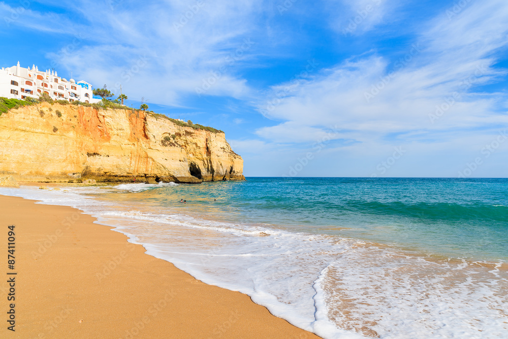 Ocean wave on sandy beach in Carvoeiro holiday village, Algarve region, Portugal