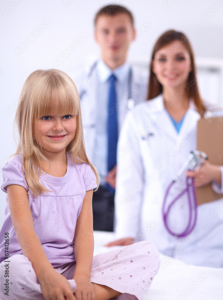 Fototapeta premium Female doctor examining child with stethoscope at surgery