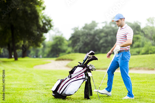 Golfer selecting appropriate club