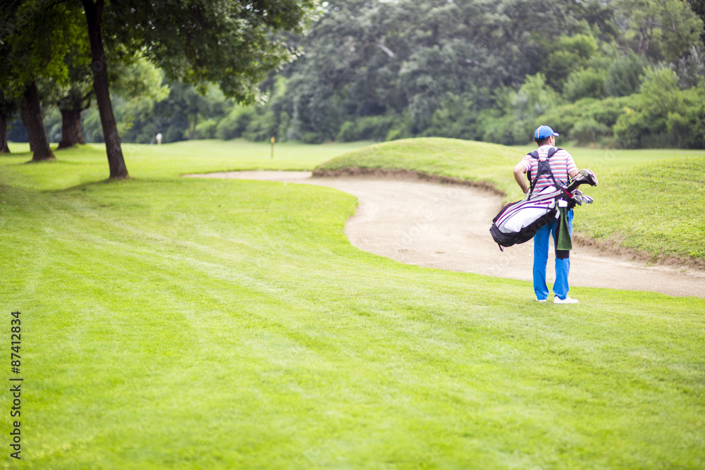 Golfer carrying his equipment Golfer carrying his equipment
