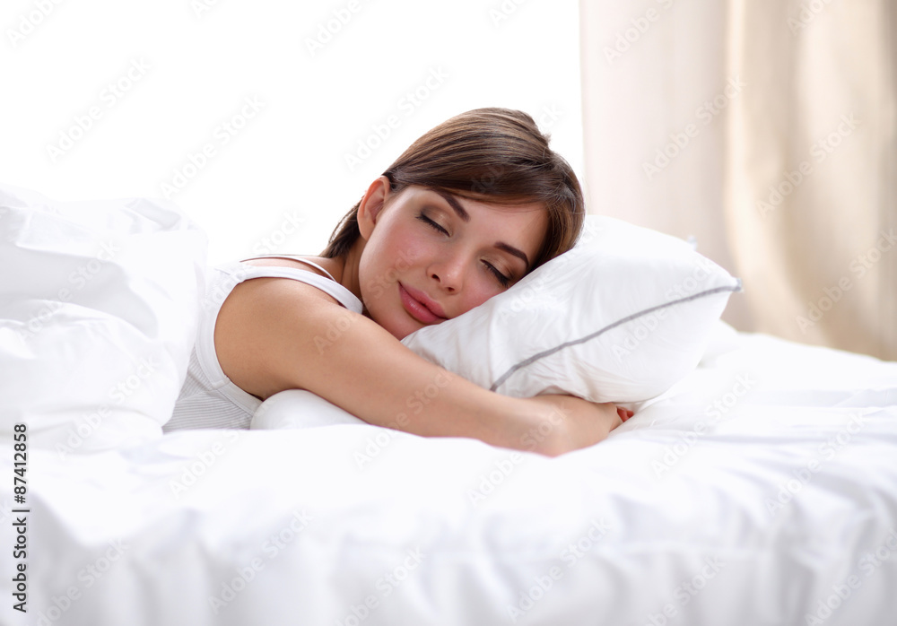Beautiful girl sleeps in the bedroom, lying on bed Beautiful girl sleeps in the bedroom, lying on bed