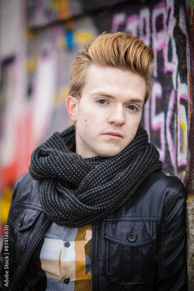 Fototapeta premium Fashion male portrait on graffiti wall