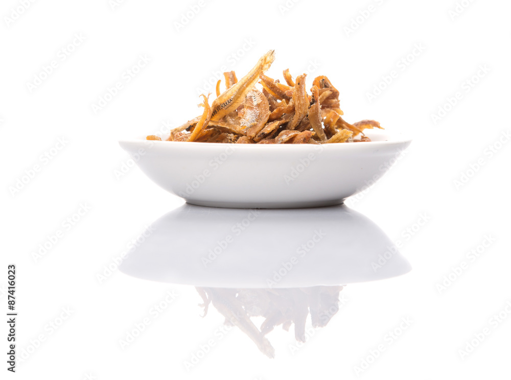 Deep fried anchovies in white bowl over white background Stock-Foto | Adobe  Stock