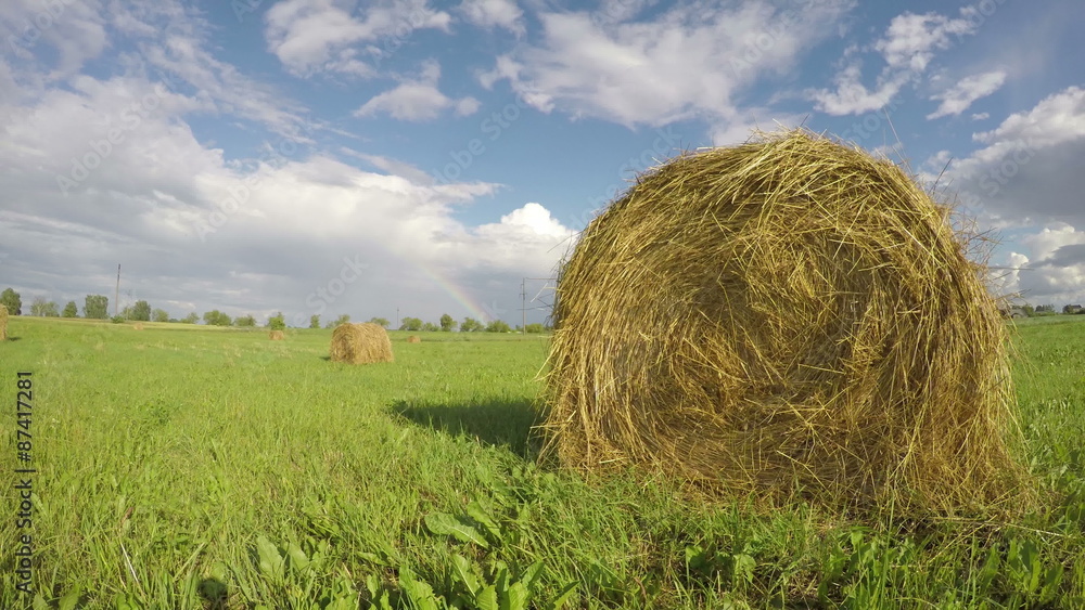 rural landscape with hay bales on agriculture field and rainbow. Timelapse 4K rural landscape with hay bales on agriculture field and rainbow. Timelapse 4K