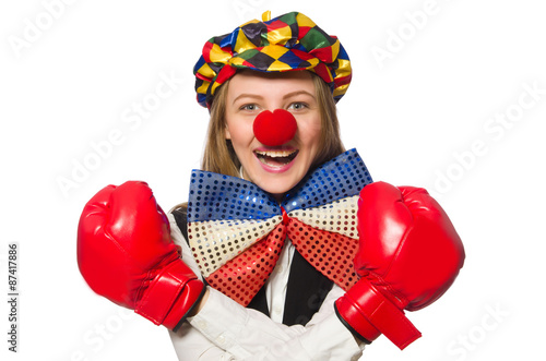 Pretty female clown with box gloves isolated on white © Elnur