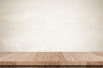 Empty wooden table over grunge cement wall background