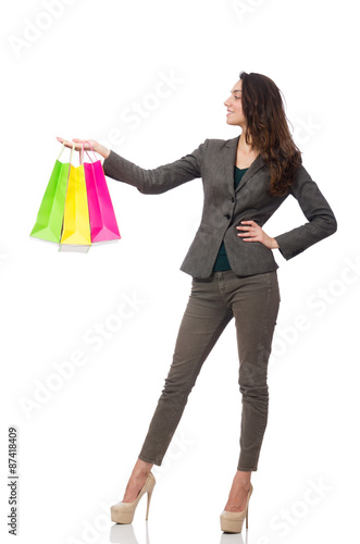 Attractive woman with shopping bags isolated on white