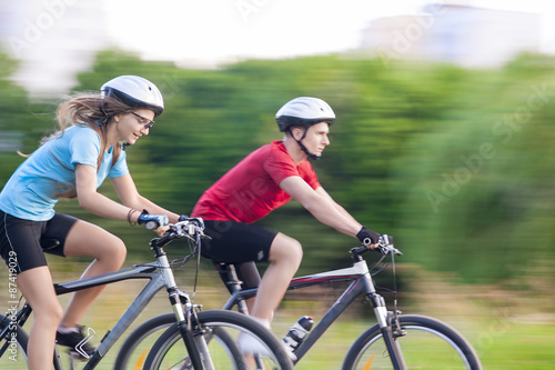 Cycling Concept: Young Caucasian Couple Having a Speedy Bicycle