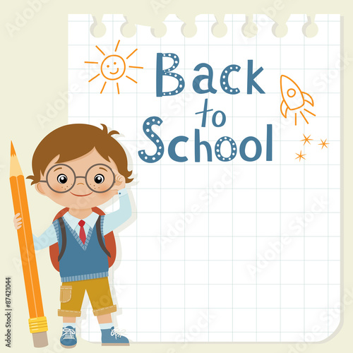 Little schoolboy with pencil is standing in front of square paper with his drawing. 