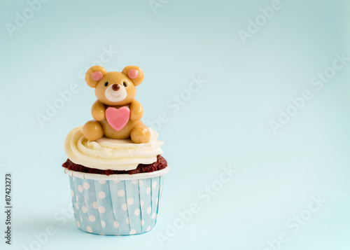 Bear cupcake on blue background