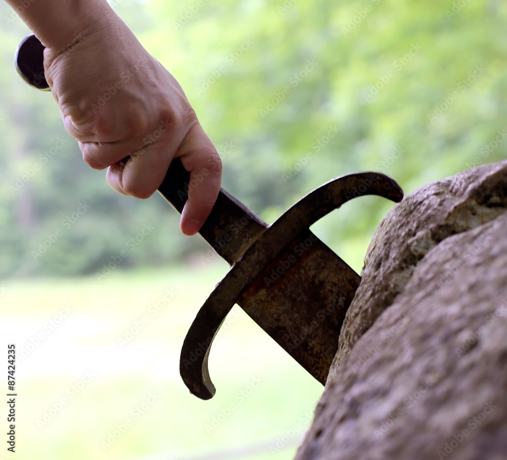 excalibur the famous sword in the stone of king Arthur in the fo Stock ...