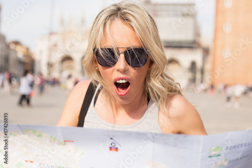 Surprised woman looking at map