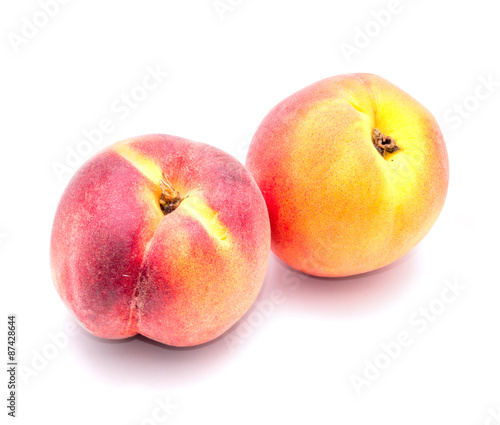 Two ripe peach on a white background