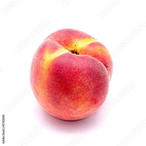 Bright juicy peach on a white background