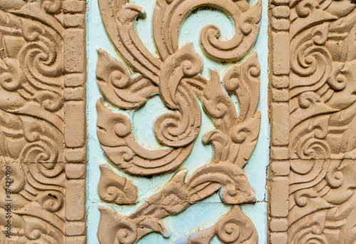 old lai thai art stucco on wall background pattern