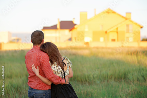 couple looking on house