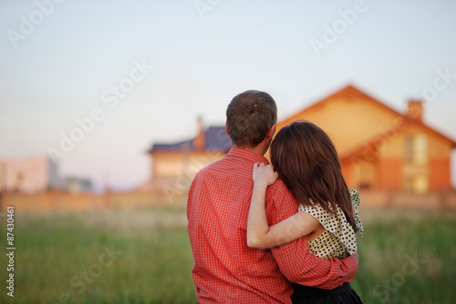 couple looking on house