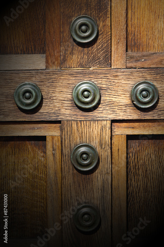 in london antique brown door rusty brass nail and light