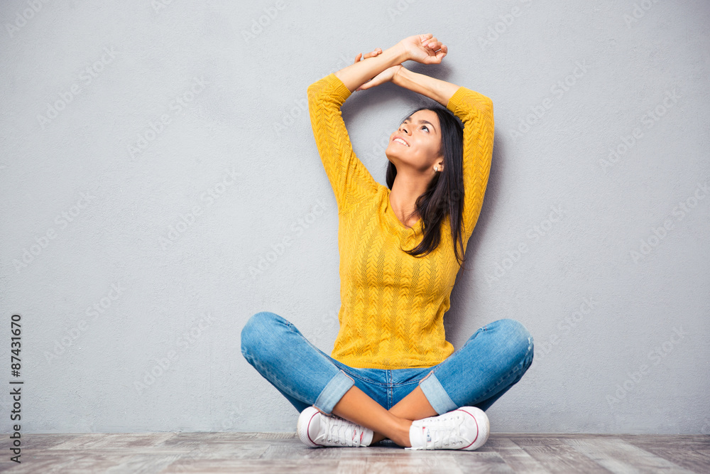 Woman sitting on the floor and looking up Woman sitting on the floor and looking up