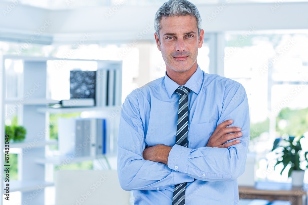 Businessman looking at camera with arms crossed Businessman looking at camera with arms crossed