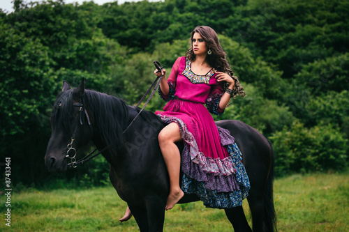 Beautiful woman on a horse © grape_vein