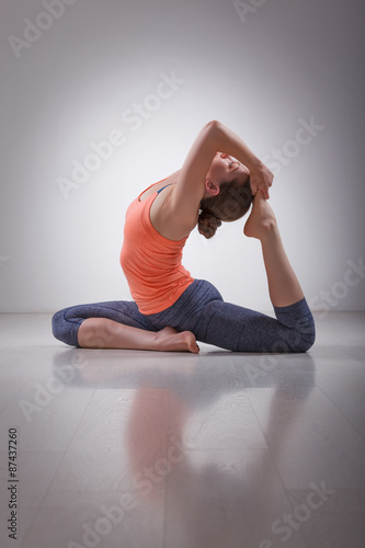 Photography Beautiful sporty fit yogi girl practices yoga asana Eka pada raj