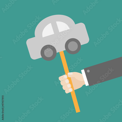 Businessman hand holding paper car on the stick Flat design photo