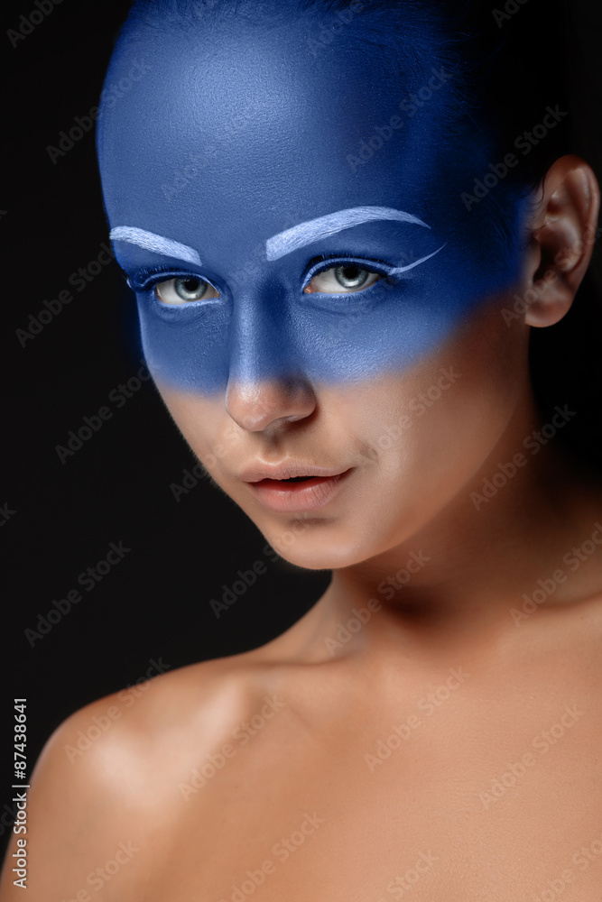 Portrait of a woman who is posing covered with blue paint Portrait of a woman who is posing covered with blue paint
