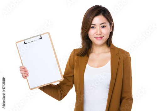 Young businesswoman show with blank page of clipboard