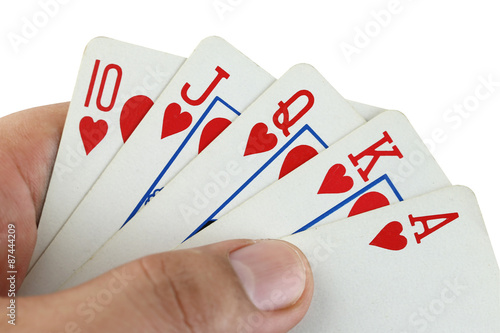 royal flush playing cards in hand.