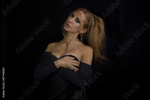 Beautiful Sexy Blond Woman. Dark Background. Smokey Eyes Makeup