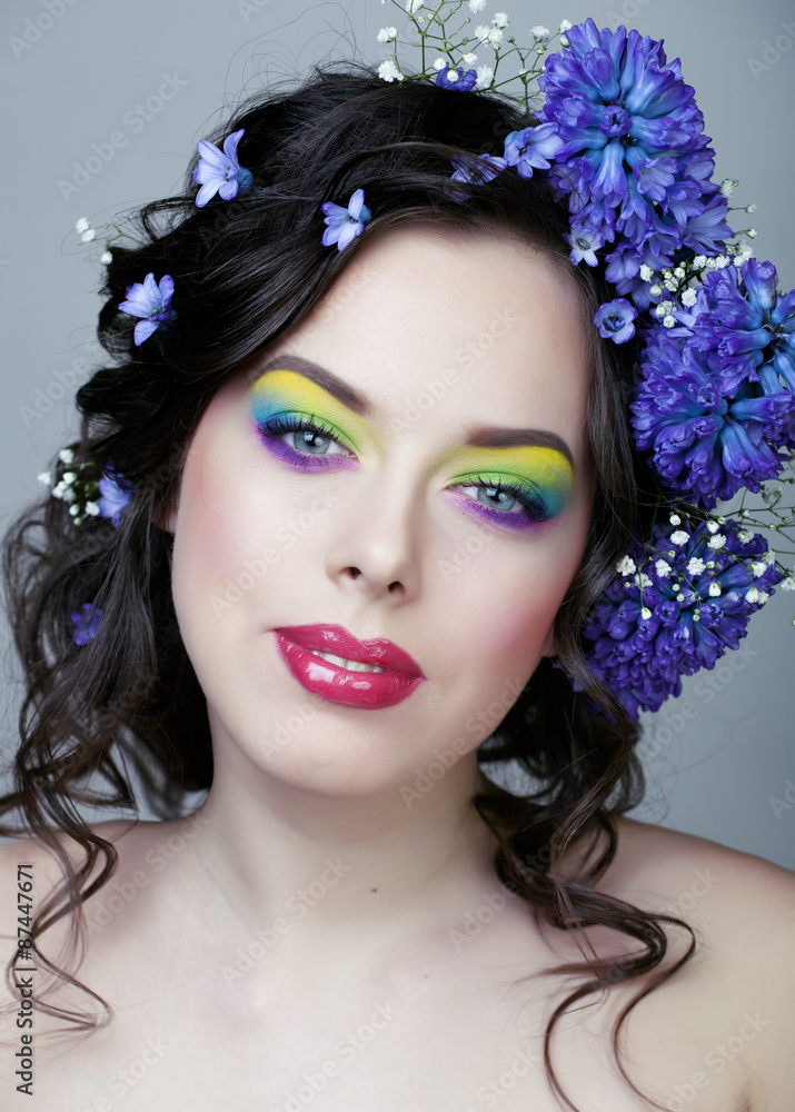 Beauty young woman with flowers and make up closeup, real spring