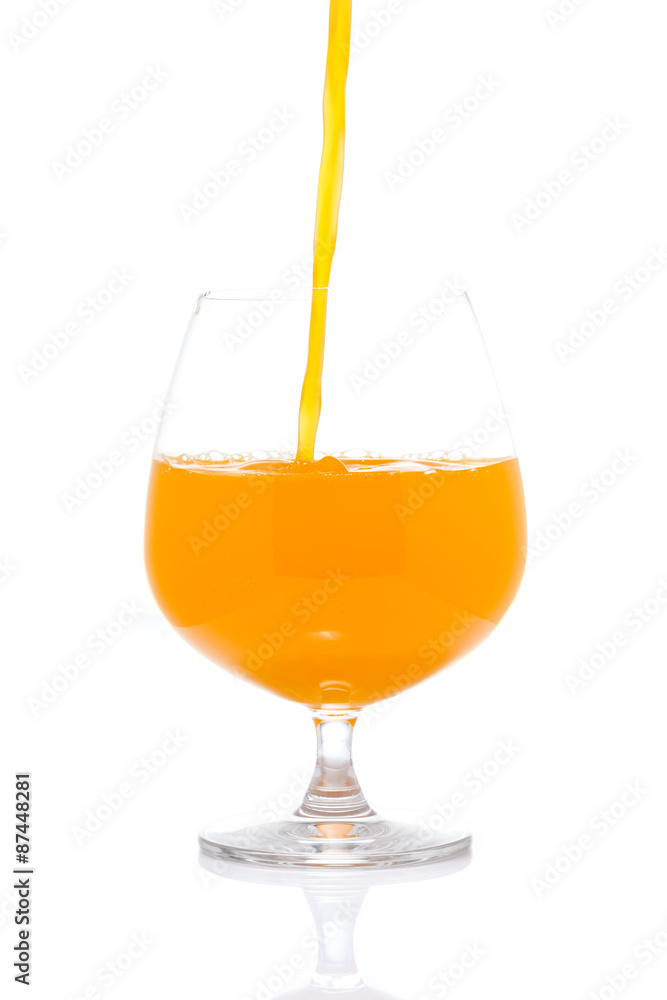 Orange Juice Pour into Wine Glass on White background Orange Juice Pour into Wine Glass on White background