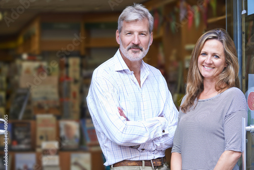 Portrait Of Couple Who Own Bookshop Outside Store photo