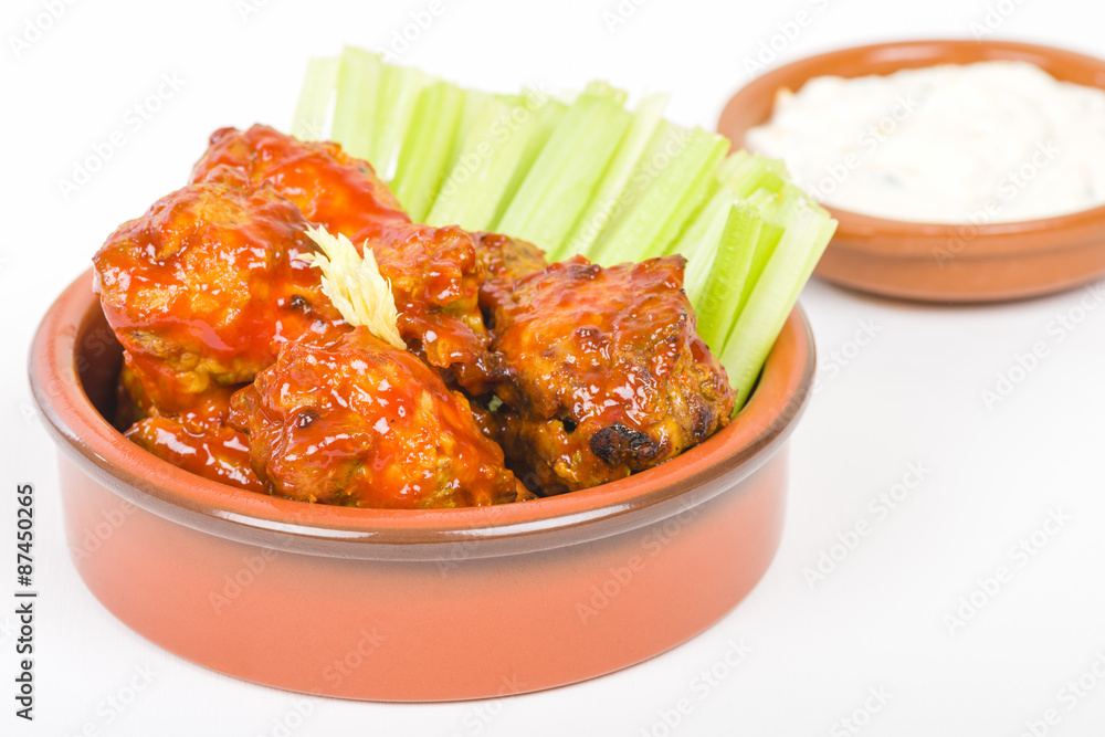 Buffalo Wings - Hot and spicy buffalo chicken wings with celery and cheese dip.
